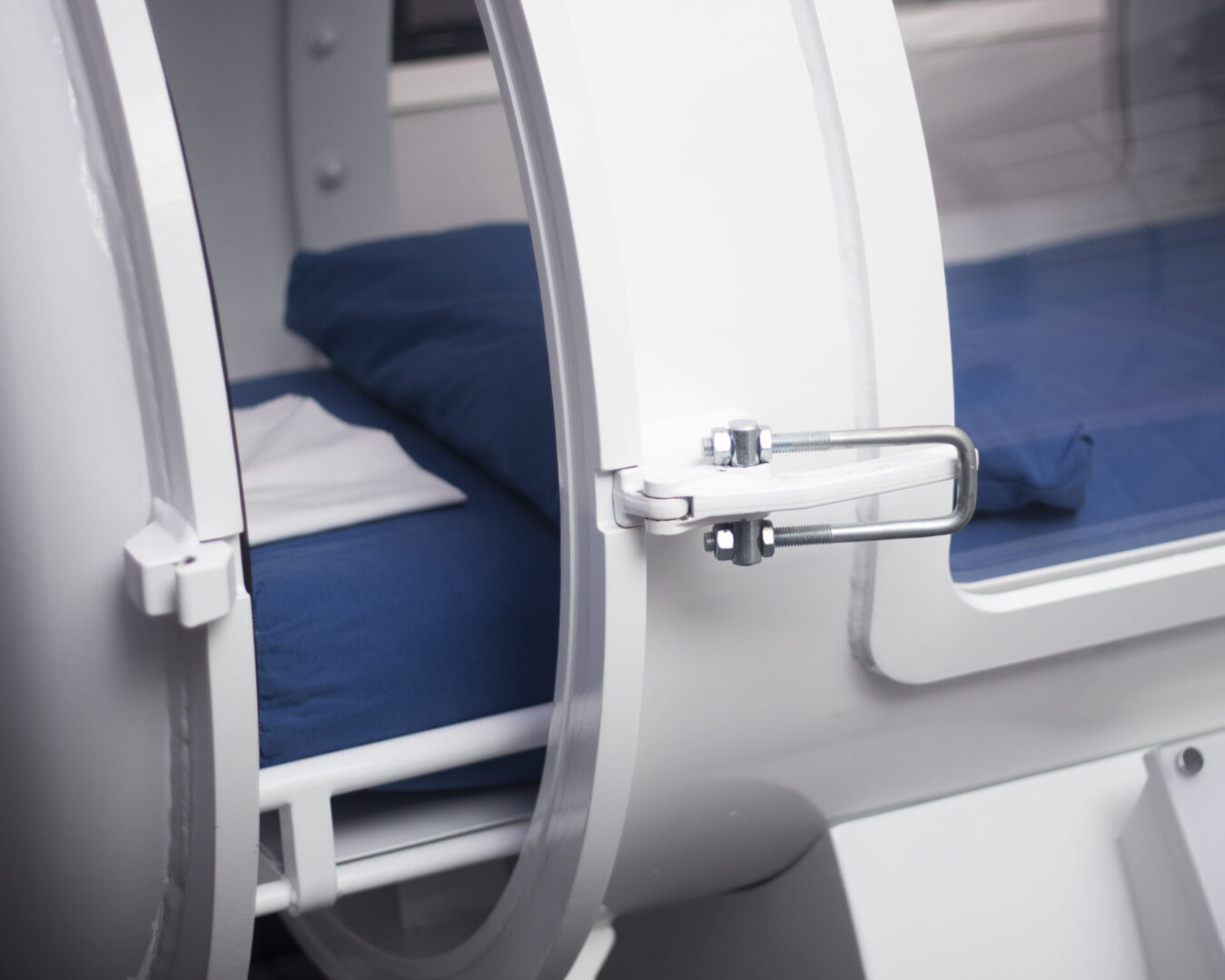 Close-up of a capsule bed door latch in a capsule hotel.