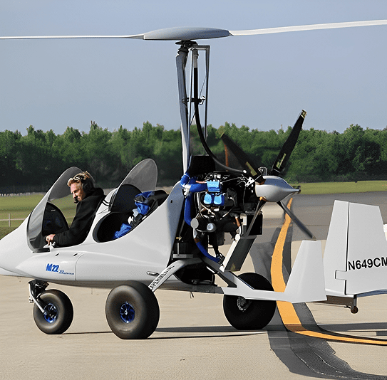 A white gyrocopter parked on a runway with a pilot inside.